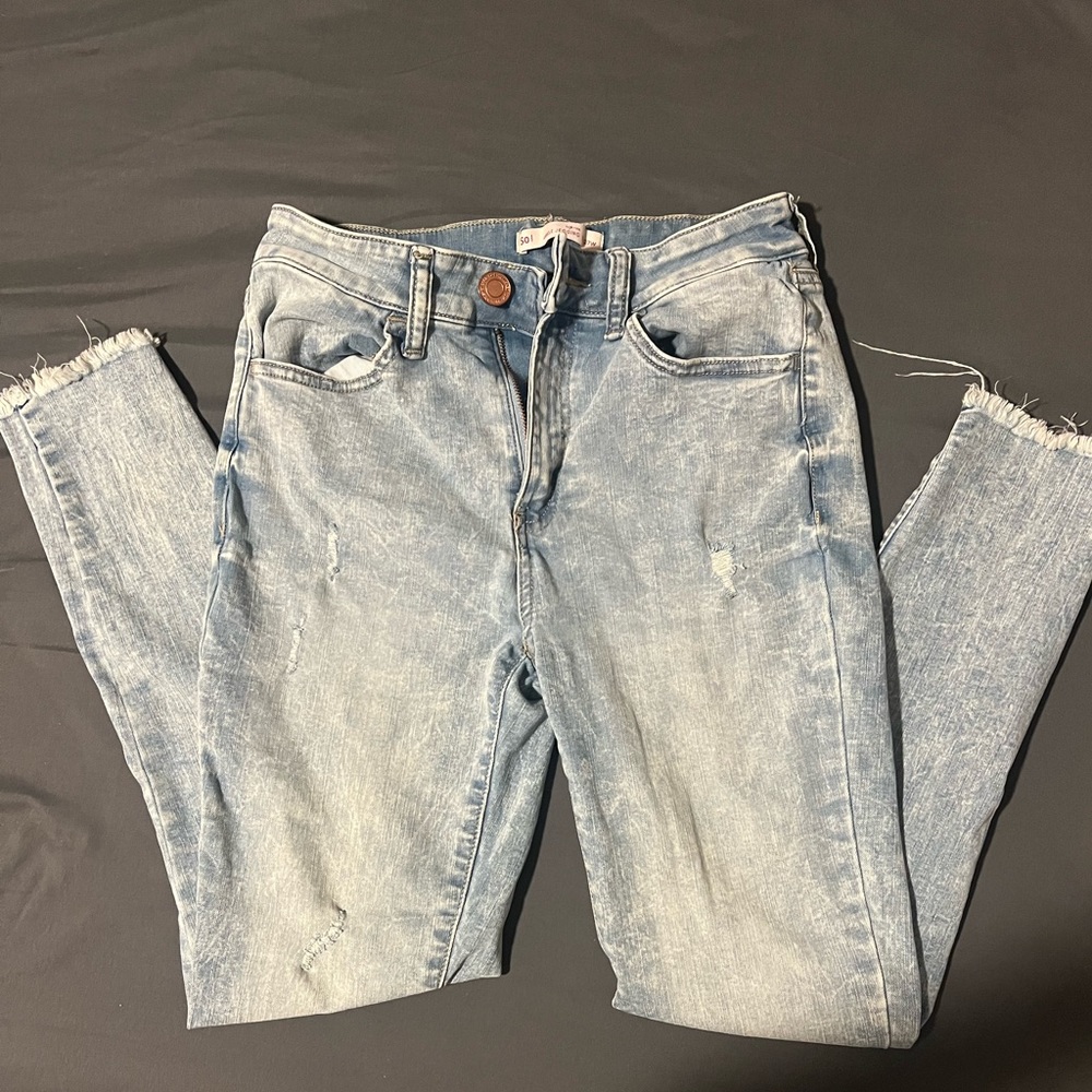 Light blue jeans with rips in knees